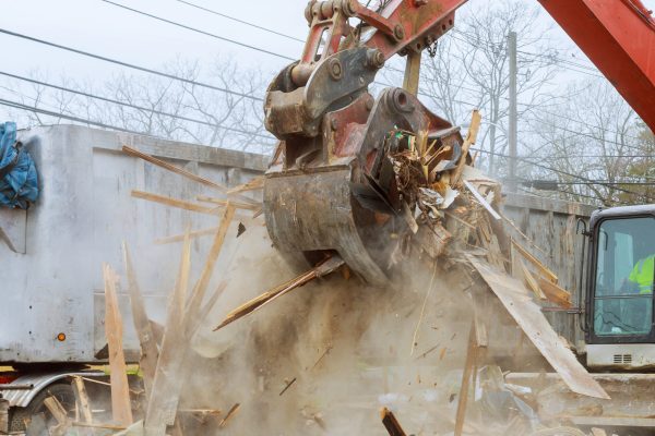 Truck with excavator loads construction waste on a dump truck Truck with excavator loads construction waste on a dump truck disposal bin